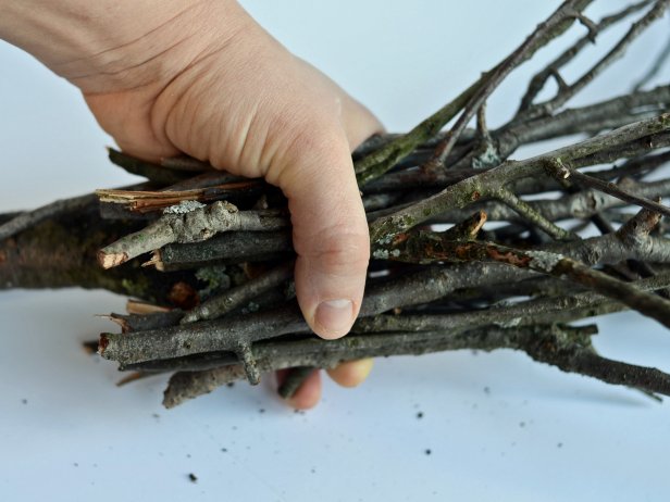 Step 7B in making a witch's broom as an accessory for a child's costume is to bunch 15-20 twigs together around the base of a 3-inch stick or dowel rod.