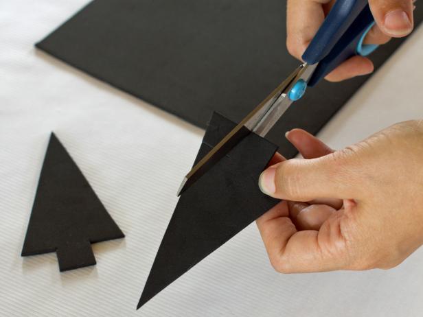Use scissors to cut two arrow-shaped ears out of a piece of black craft foam