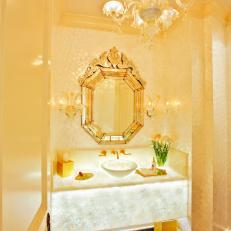 Monochromatic Gold Powder Room with Black Marble Tile