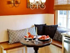 Orange breakfast nook with built-in banquette