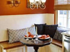 Orange breakfast nook with built-in banquette