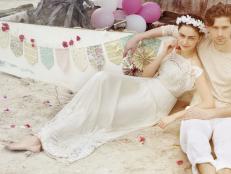 Bride With White Floral Crown Reclining on Beach