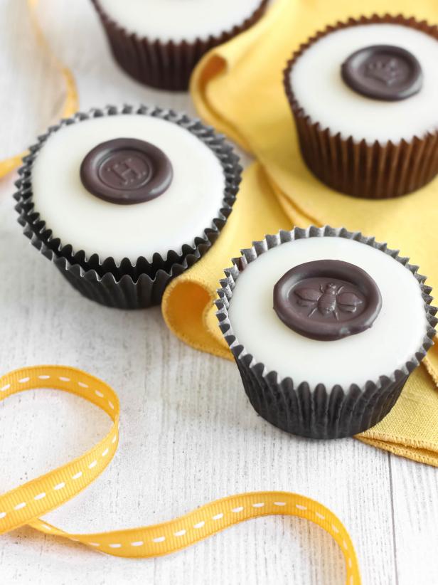White Cupcakes With Chocolate Seals With Yellow Ribbon
