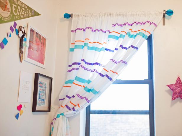 A multicolor striped curtain is a playful accent to this contemporary girls bedroom.