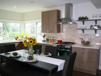 Neutral Kitchen With Stainless Steel Range Hood and Black Dining Table