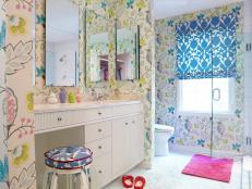 Designer Rebecca Hawkins uses bright, bold colors, lots of mirrors and abundant storage space in a bathroom design that suits two young sisters.
