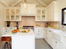 Designer Christopher Grubb combines white cabinetry, stainless steel appliances and rustic touches to create an updated farmhouse kitchen.