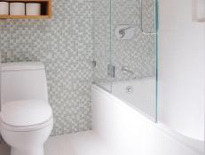 Designer Jennifer Jones opens up a small bathroom with a white color palette, glass and stunning mosaic tiles.