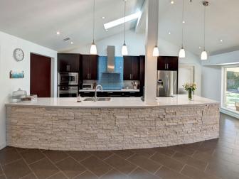 Modern Kitchen With Stone Accents and Dark Cabinets 