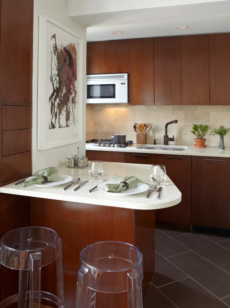 Small Modern Kitchen With Sleek Brown Cabinets and White Countertops