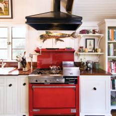 White Cottage Kitchen With Red Oven and Black Range Hood 