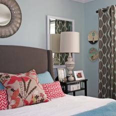 An Eclectic Bedroom With Blue Walls and Mix and Matched Patterns