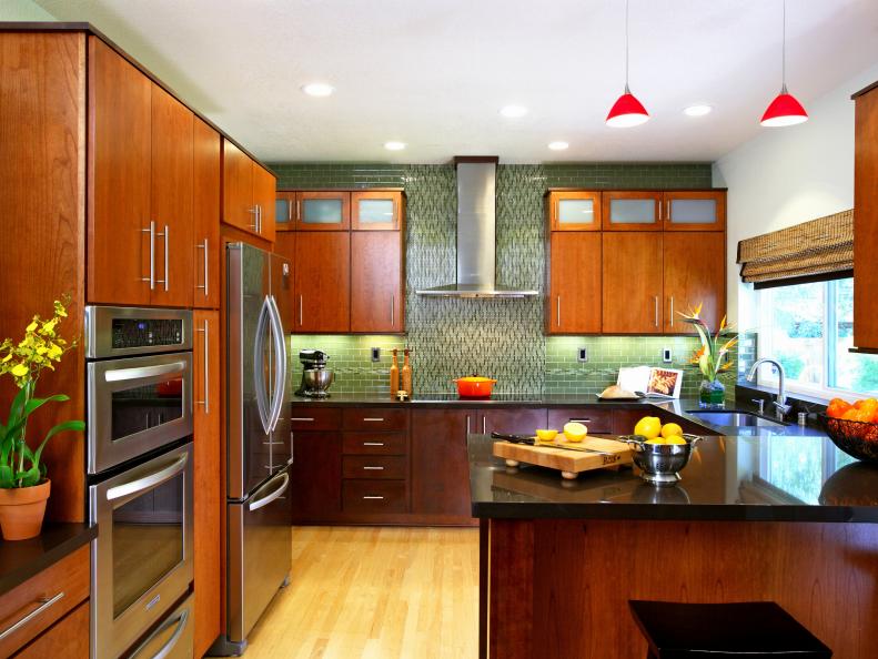 Modern Kitchen With Green Backsplash and Dark Wood Cabinets 