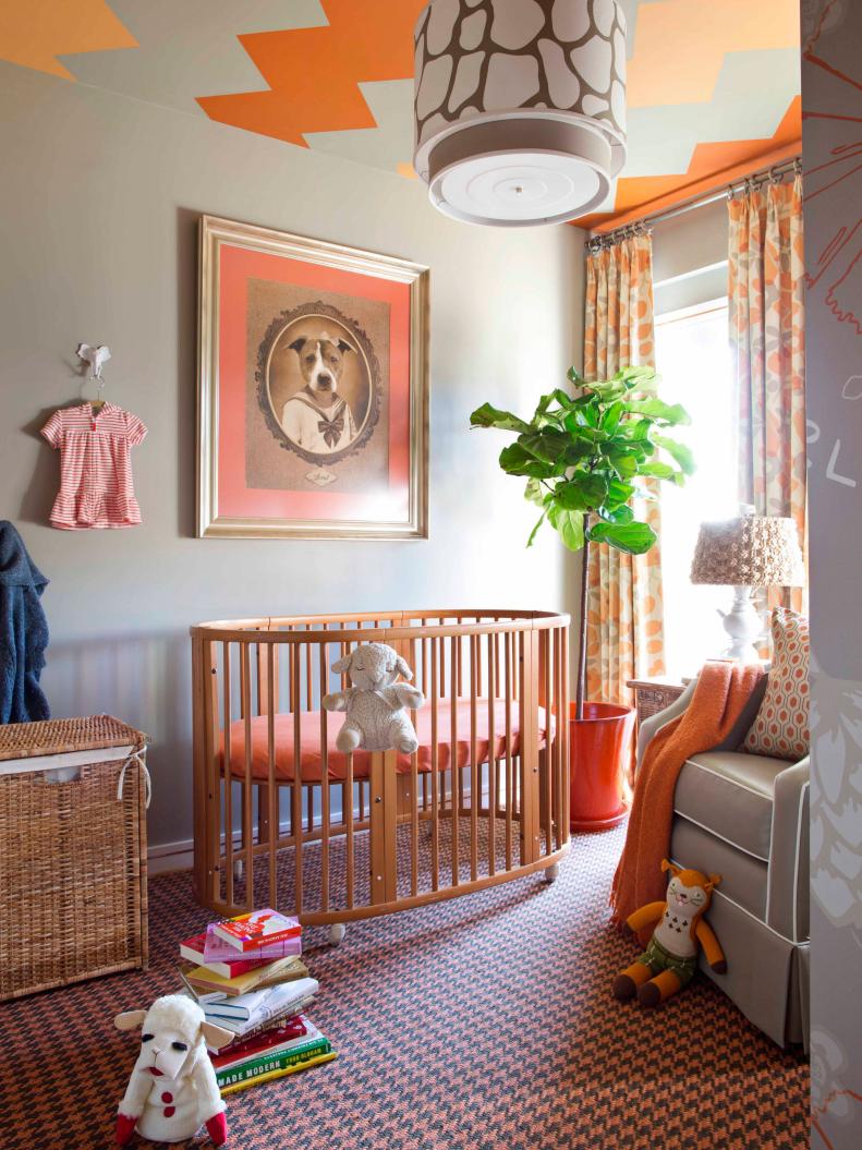 Nursery With Orange and Gray Chevron Ceiling and Wood Crib 