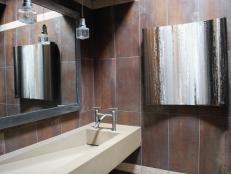 Designer Andrea Wachs combines natural stones and metals for an industrial yet earthy look in this bathroom design.