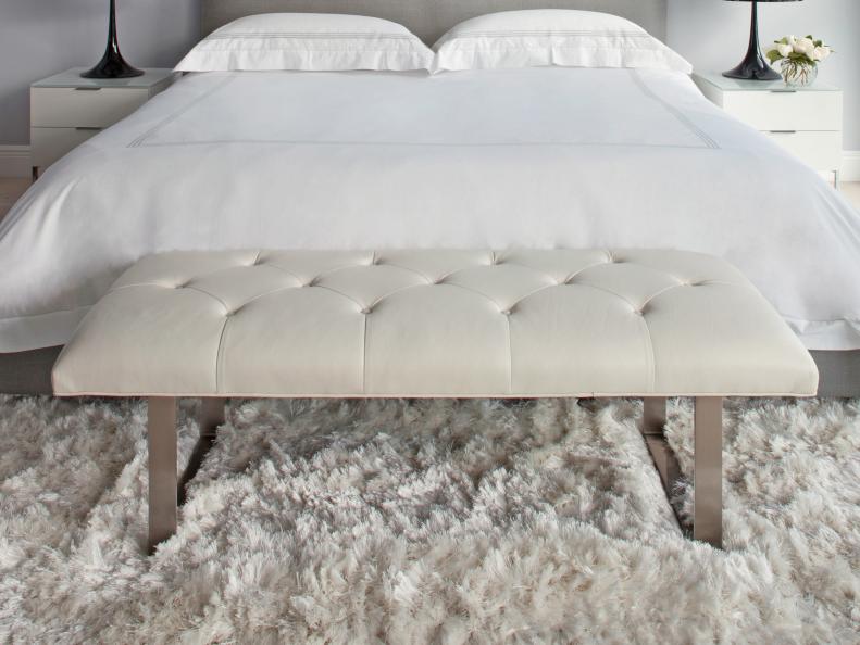Tufted bench at the base of bed