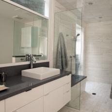 Modern White Bathroom With Dark Gray Accents and Vessel Sink