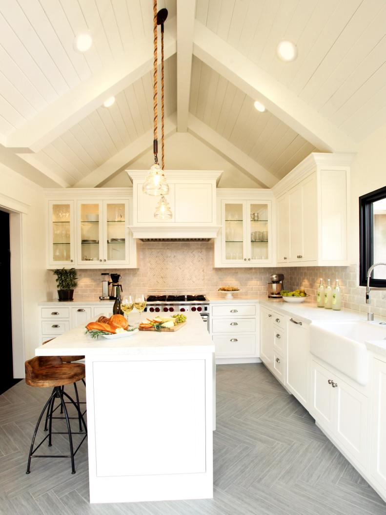 Kitchen With White Cabinets, Vaulted Ceiling and Large White Island