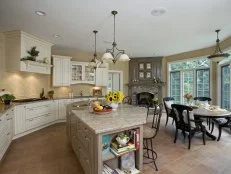 Open kitchen with dining table and fireplace