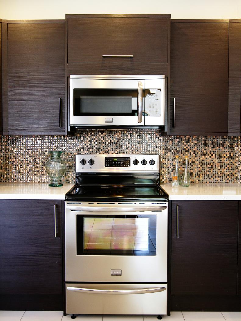 Kitchen With Dark Wood Cabinets and Metallic Mosaic Tile Backsplash