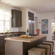 Brown and White Open Plan Contemporary Kitchen With Suede Stools