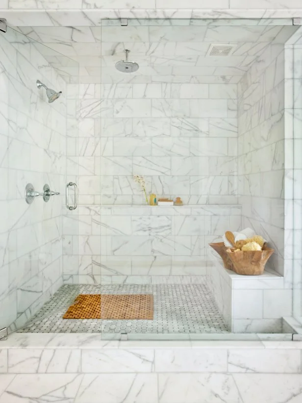 Large white marble tile shower with glass door