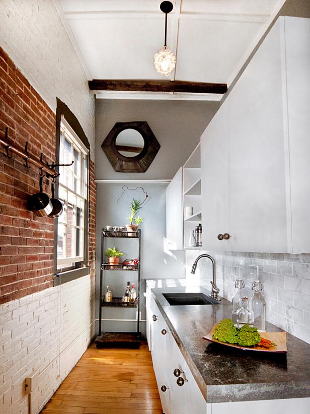 Kitchen In A Loft Style With Concrete And Brick Walls And Tiles A