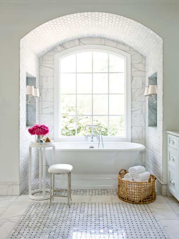 Slipper Tub Surrounded by Marble in an Elegant, Traditional Bathroom 