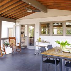 Screened Patio With Gray Tile Floor and Exposed Beams