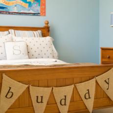 Blue Boys Bedroom With Wooden Bed