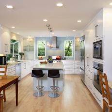 Contemporary White Kitchen With Island and Black Bar Stools