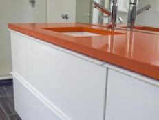 Orange Bathroom Countertop And White Drawers