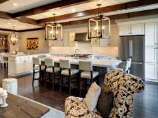 Open Plan Kitchen With Large Island, White Barstools and Wood Lanterns