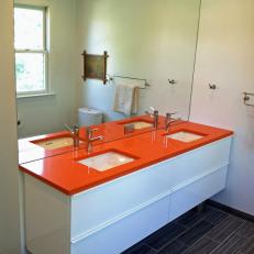 Modern White Bathroom With Bold Orange Countertop