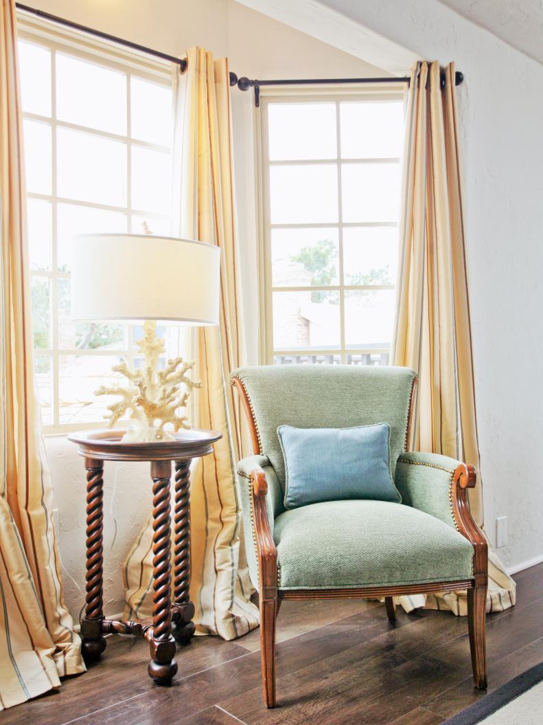 Neutral Living Room With Bay Window, Green Chair and White Coral Lamp