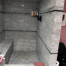 Contemporary Gray Stone Shower With Bench