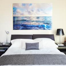 White Contemporary Bedroom With Vibrant Ocean Artwork