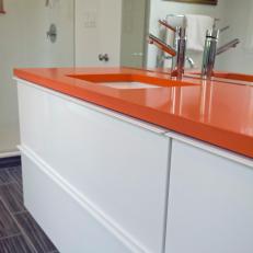 Orange Countertop on Contemporary White Vanity