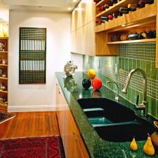 Kitchen With Green Tile Backsplash and Wine Racks 