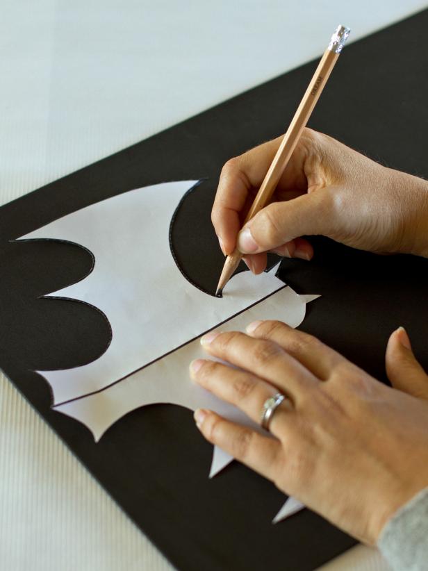Use a pencil to trace the shape of the bat onto a piece of black craft foam, and then cut it out.