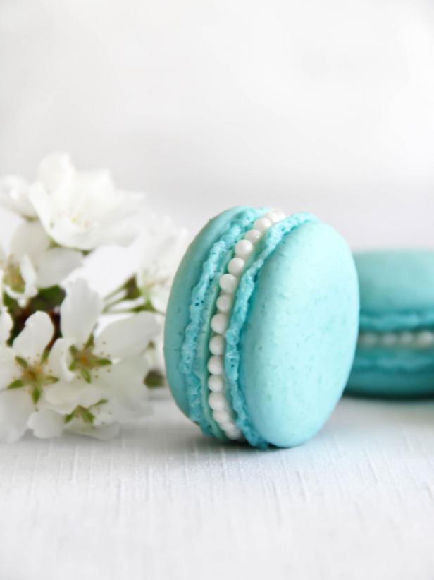 The finished product after adding a line of pearl dragees to the exposed orange blossom buttercream of these Tiffany Blue macarons.