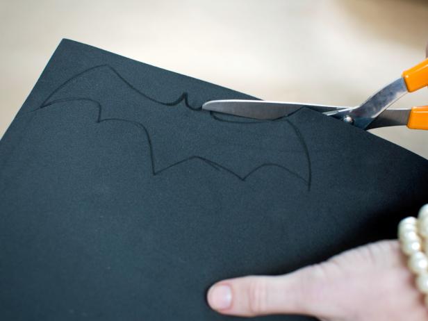 Trace or freehand the silhouette of a bat onto craft foam with black pen or marker then cut out silhouette with scissors. Repeat the process to make multiple bats in assorted sizes.