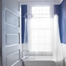 Blue and White Bathroom With Freestanding Bathtub