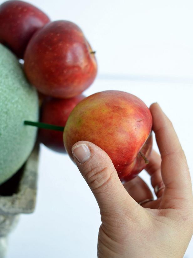 Press bottom of an apple or pear into a floral skewer to create a topiary centerpiece. Tip: Smaller fruit works best for this project. Large pieces may be too heavy for skewers.