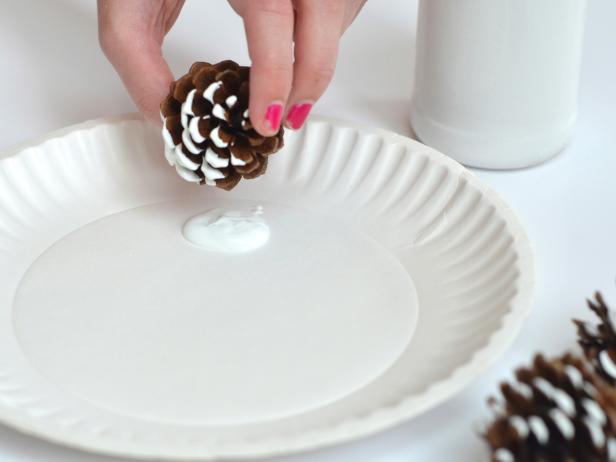 Dipping Pinecone's Edges in White Paint