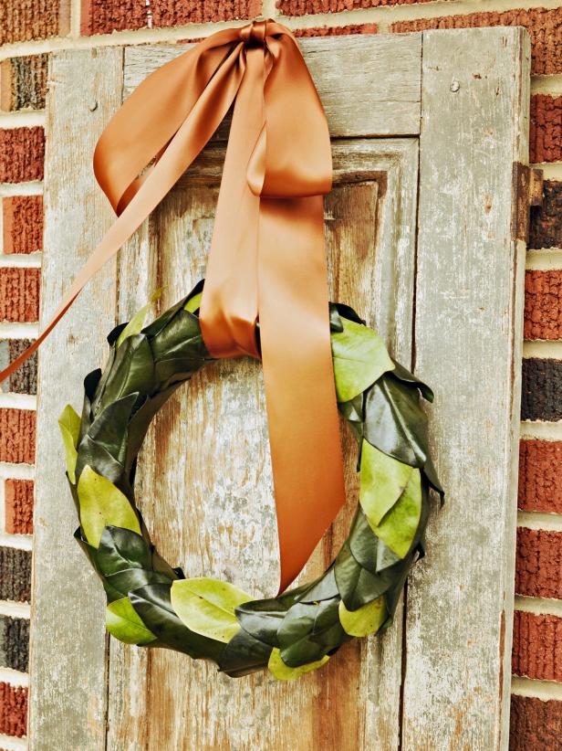 Wreaths don't have to be full and fluffy to be beautiful.  Try making this simple, modern take on the traditional holiday wreath with preserved or freshly cut magnolia leaves.