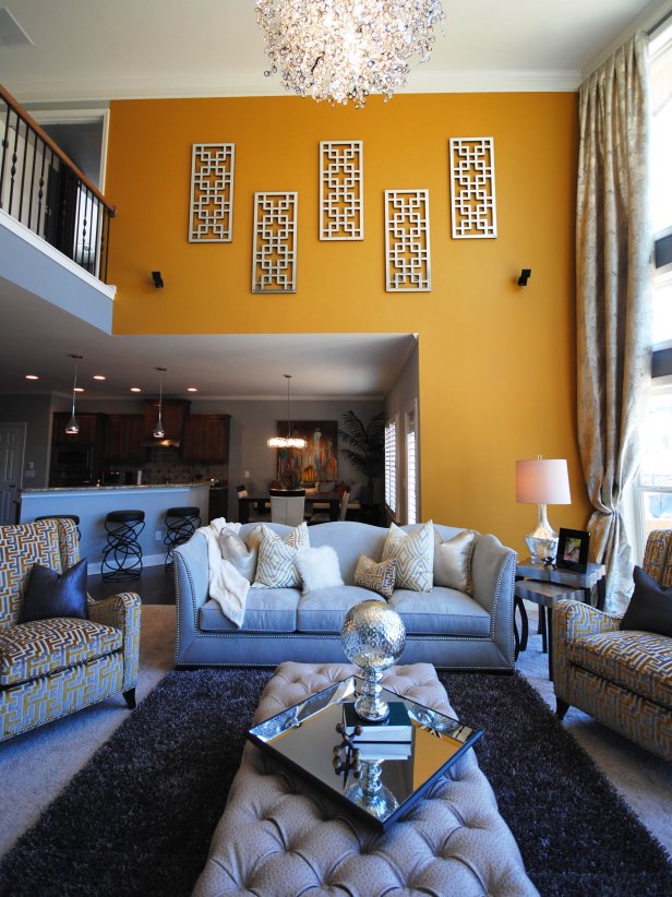 Open yellow living room with loft hallway