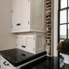 Traditional Kitchen with White Cabinets and Brick Walls