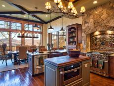 Designer Heather Guss incorporated wood trim and decorative stone accents to give this transitional kitchen area country appeal.