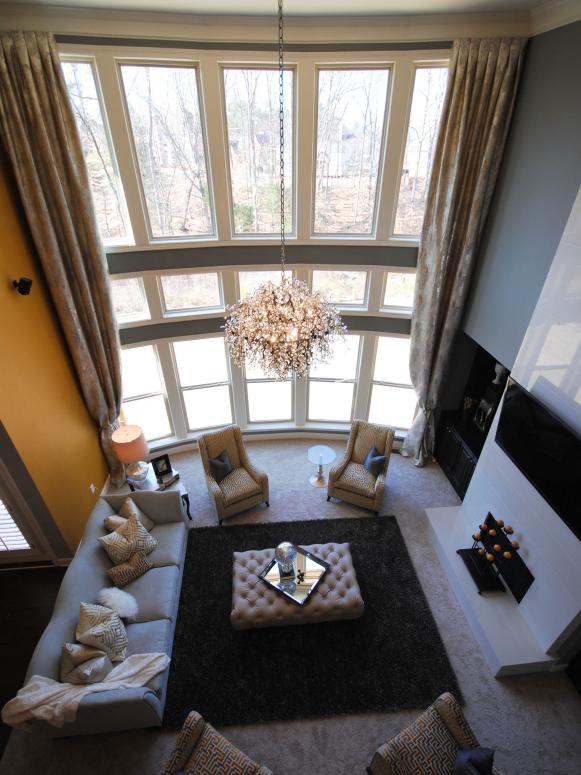 Gray & Yellow Living Room With Two-Story Windows and Chandelier